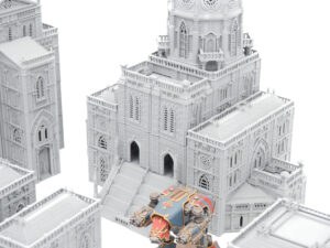 Grey 3D-printed gothic cathedral tabletop terrain shown with a painted miniature for scale