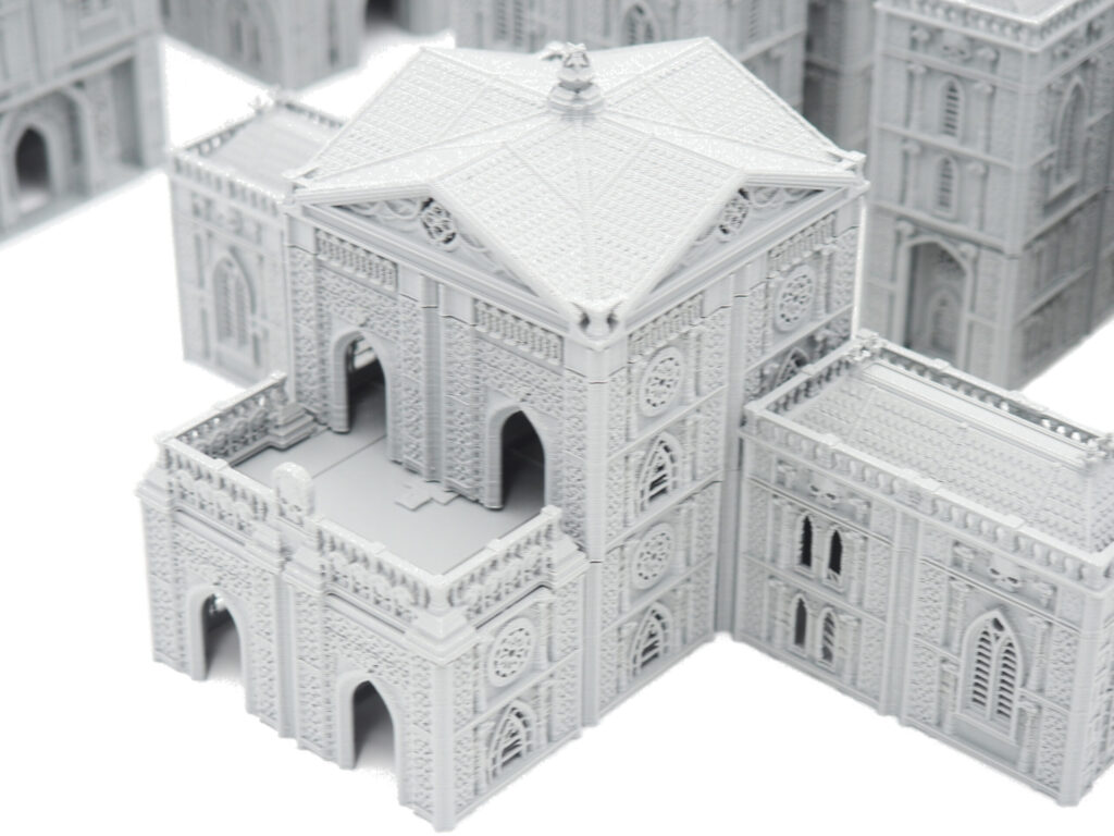 Grey 3D-printed gothic miniature building with detailed stone walls and arched doorways for tabletop gaming