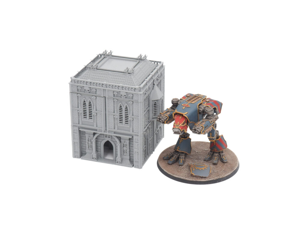 Grey 3D printed gothic building miniature shown next to a painted sci-fi mech figure for tabletop gaming scale