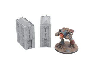 Two unpainted grey 3D-printed gothic miniature buildings shown next to a painted sci-fi mech for scale