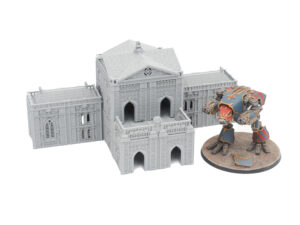 Grey 3D-printed gothic building terrain shown next to a painted tabletop miniature for scale