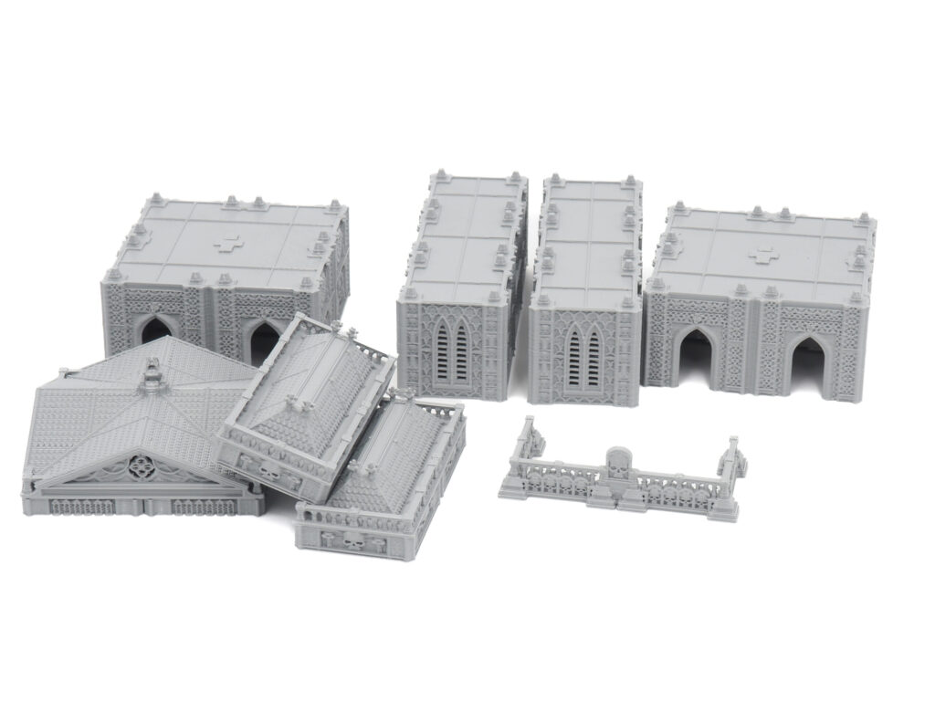 Grey 3D-printed gothic miniature building terrain and fence pieces for tabletop gaming, on a white background