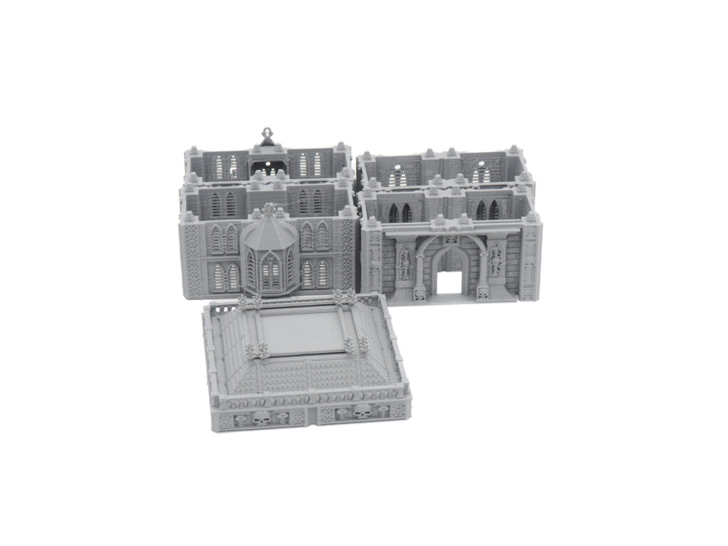 Grey 3D-printed modular gothic terrain pieces for tabletop wargaming, including detailed walls and a roof section