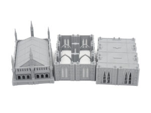 Three grey 3D-printed gothic modular building terrain pieces for tabletop wargaming on a white background