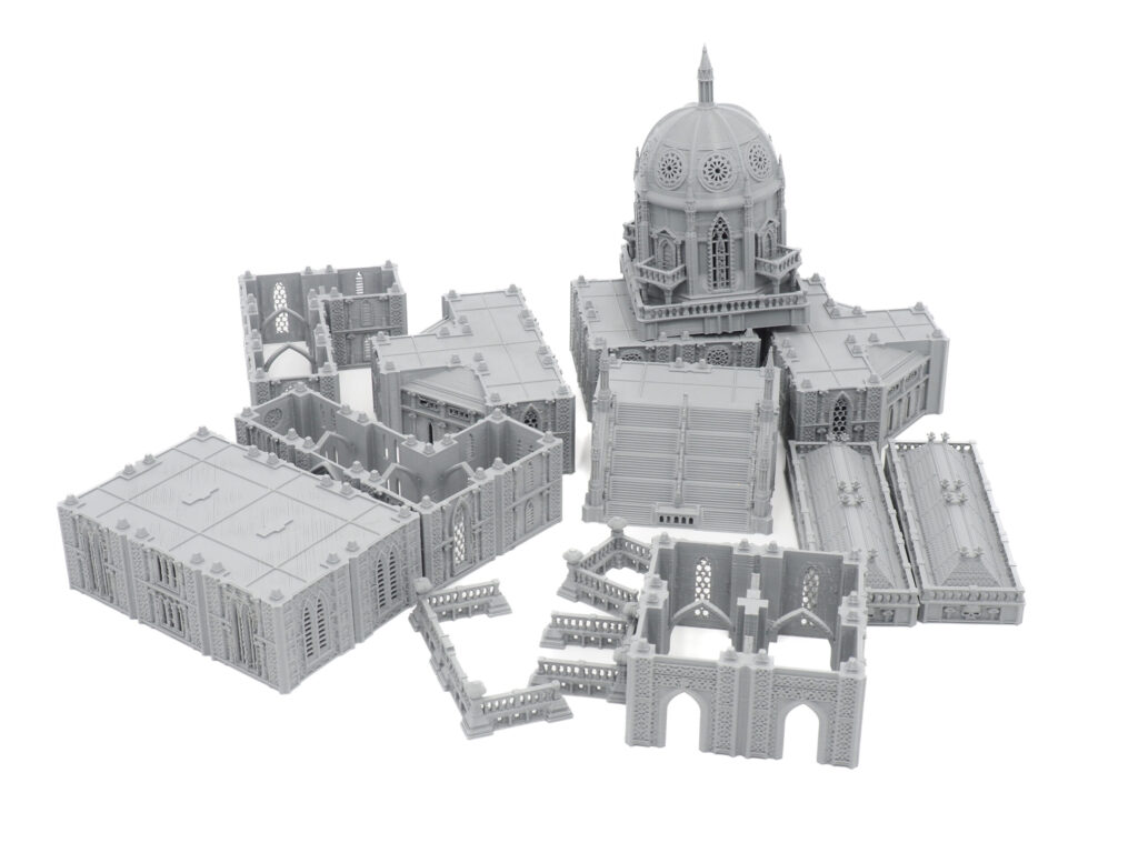 Modular grey 3D printed Gothic cathedral miniature terrain pieces for tabletop gaming, on a plain white background