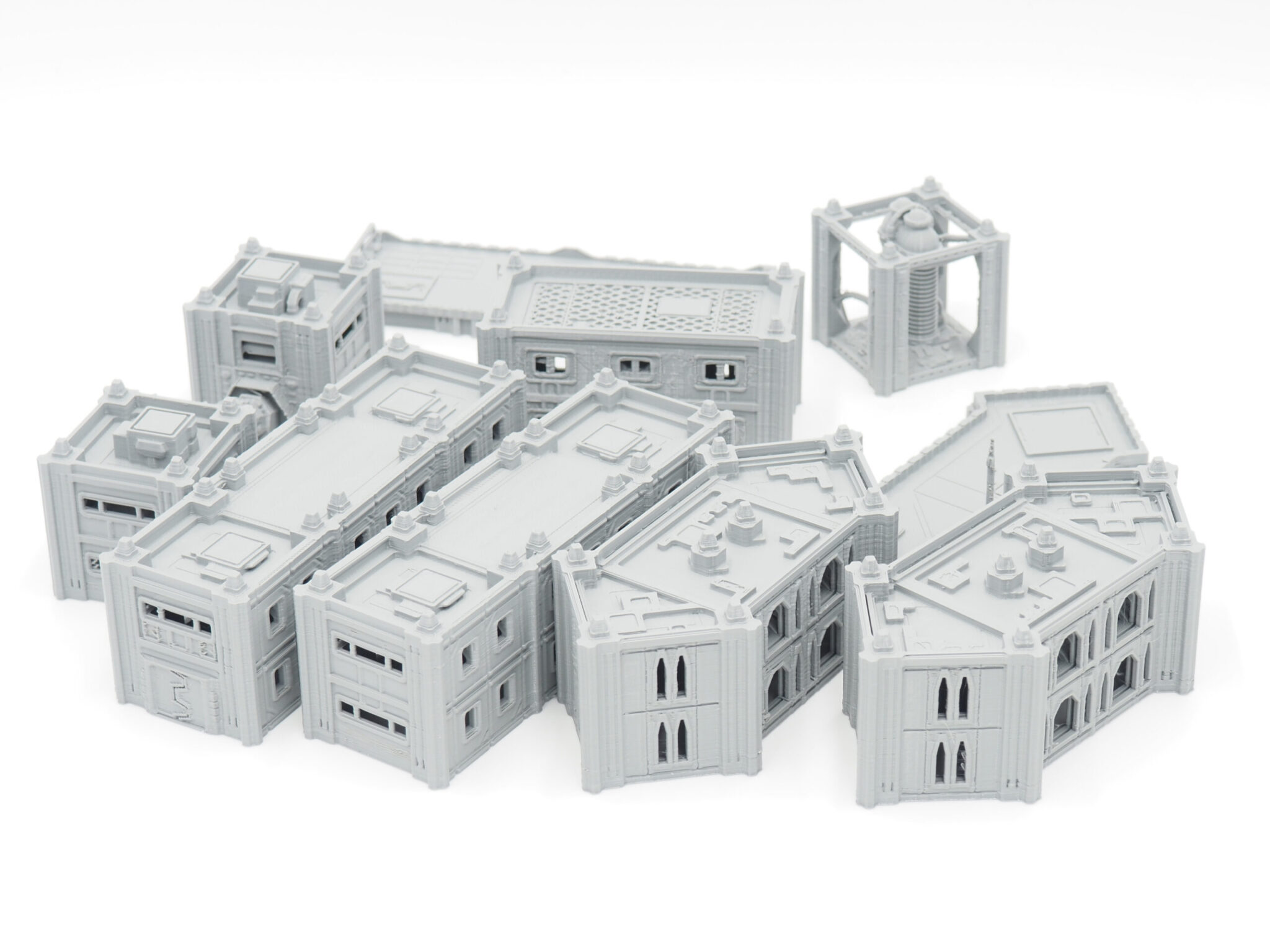 Modular grey 3D-printed sci-fi miniature buildings for tabletop gaming on a white background