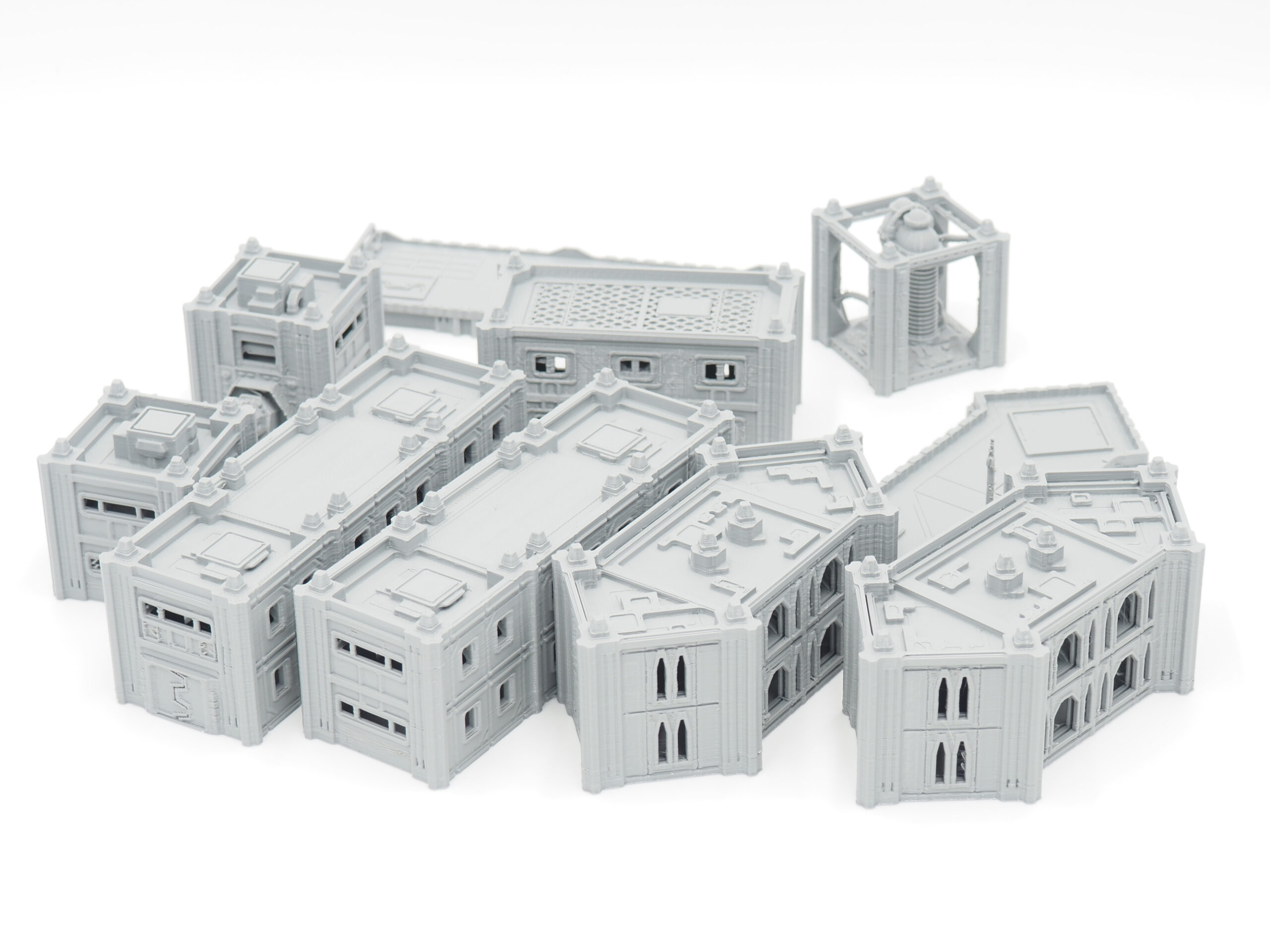 Modular grey 3D-printed sci-fi miniature buildings for tabletop gaming on a white background
