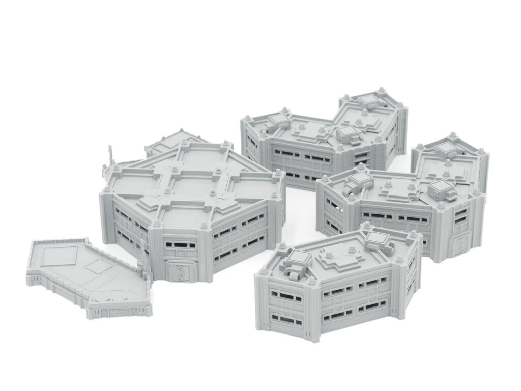 Grey 3D-printed modular sci-fi building terrain miniatures for tabletop gaming, arranged on a white background