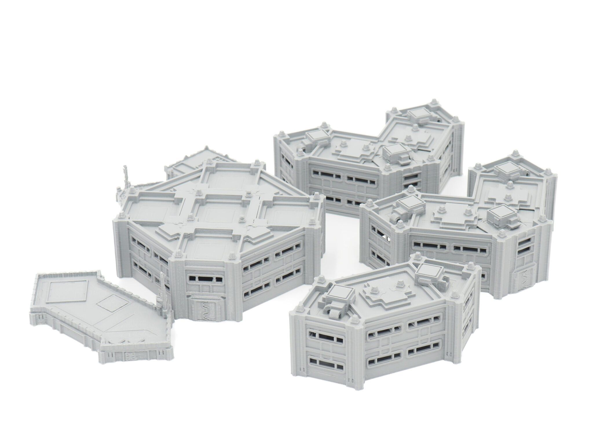 Grey 3D-printed modular sci-fi building terrain miniatures for tabletop gaming, arranged on a white background