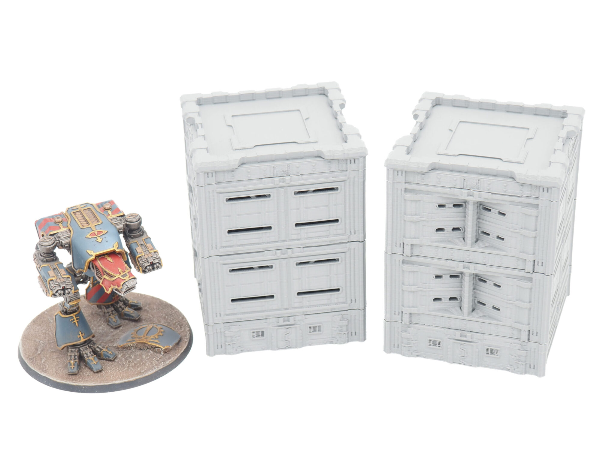 Two grey 3D-printed modular sci-fi buildings shown alongside a painted mech figurine for size comparison