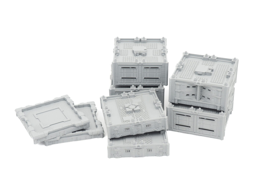 Grey 3D-printed modular sci-fi terrain blocks and panels on a white background
