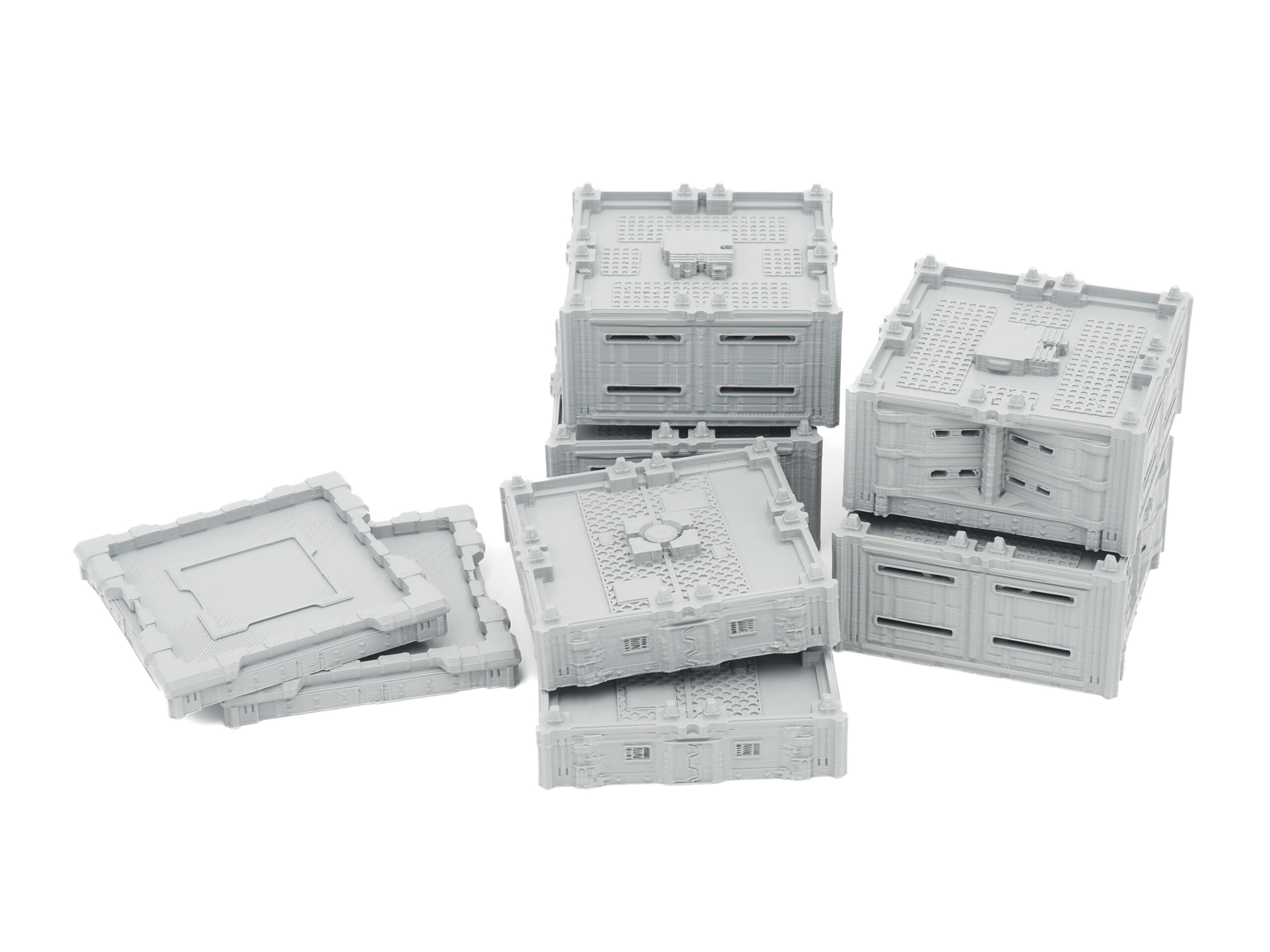 Grey 3D-printed modular sci-fi terrain blocks and panels on a white background