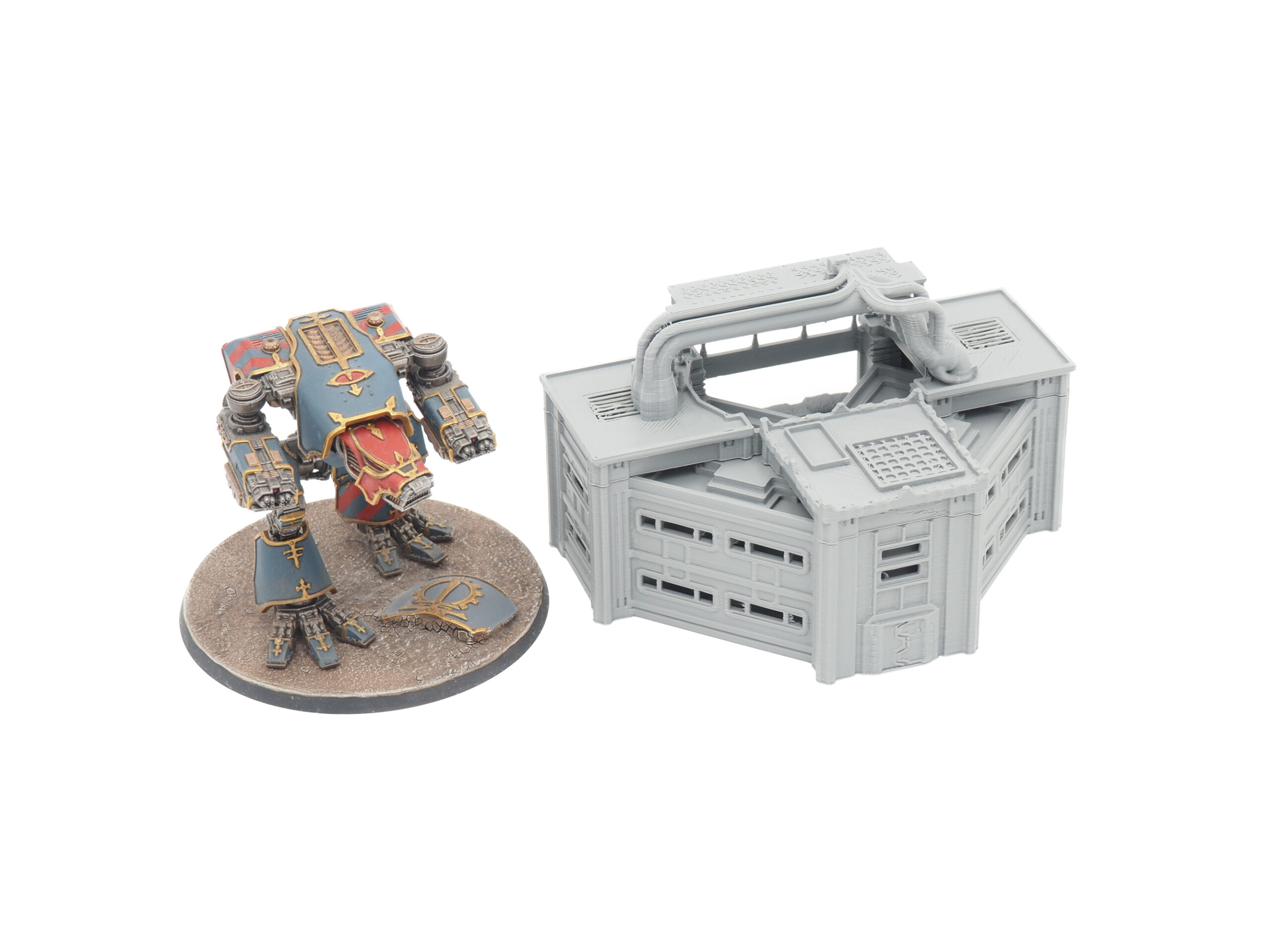 Grey 3D-printed sci-fi building terrain piece next to a painted miniature mech for scale