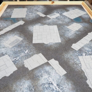 Grey 3D-printed modular stone tiles and paths for tabletop gaming, arranged on a textured battle mat