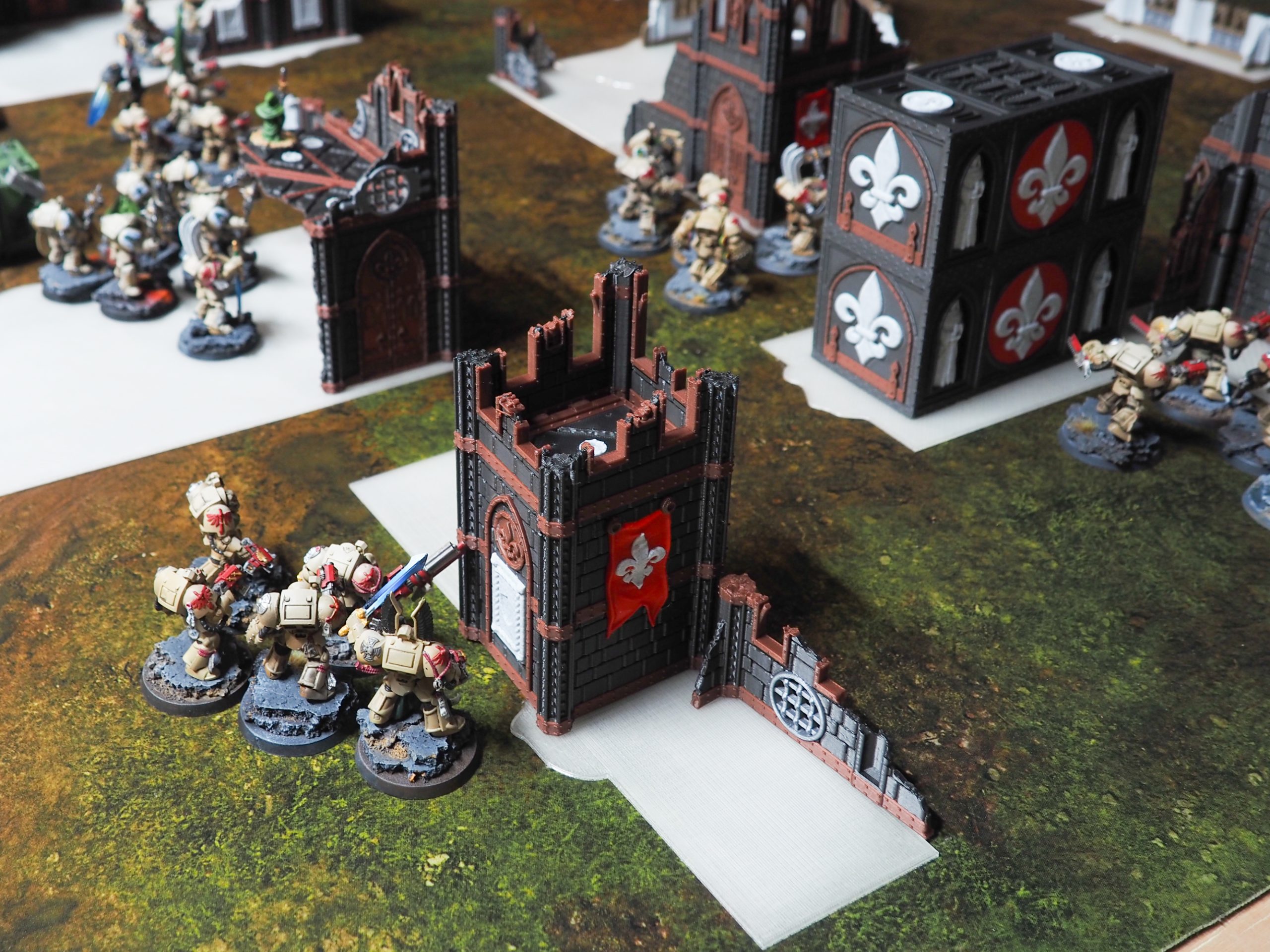 3D-printed gothic watchtower and wall terrain displayed with tabletop wargaming miniatures