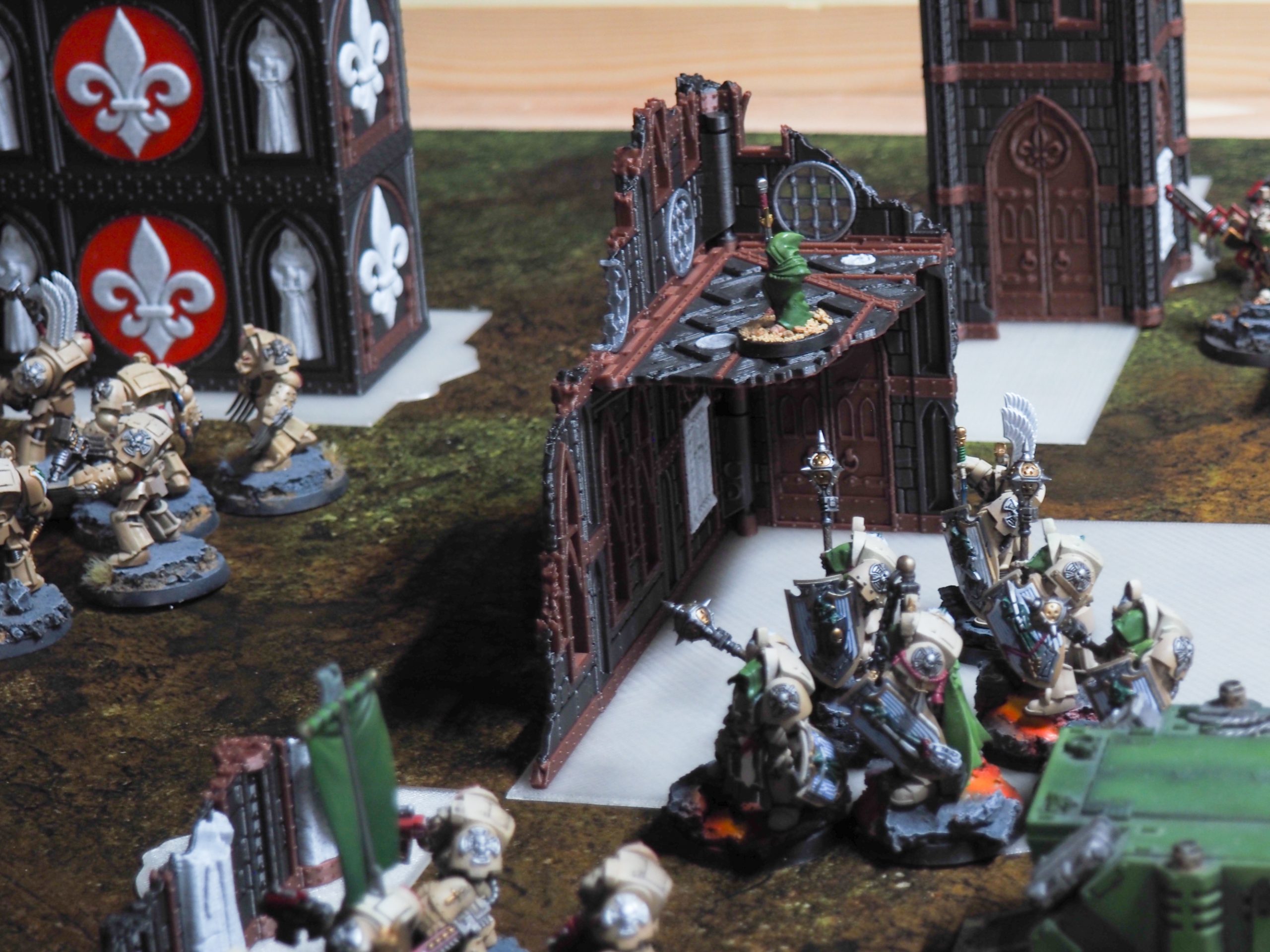 3D-printed gothic ruin terrain corner piece surrounded by painted tabletop wargame miniatures