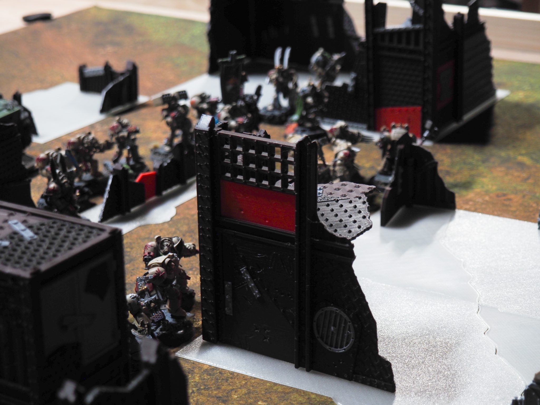 3D-printed modular sci-fi terrain walls and barricades shown with painted tabletop miniatures