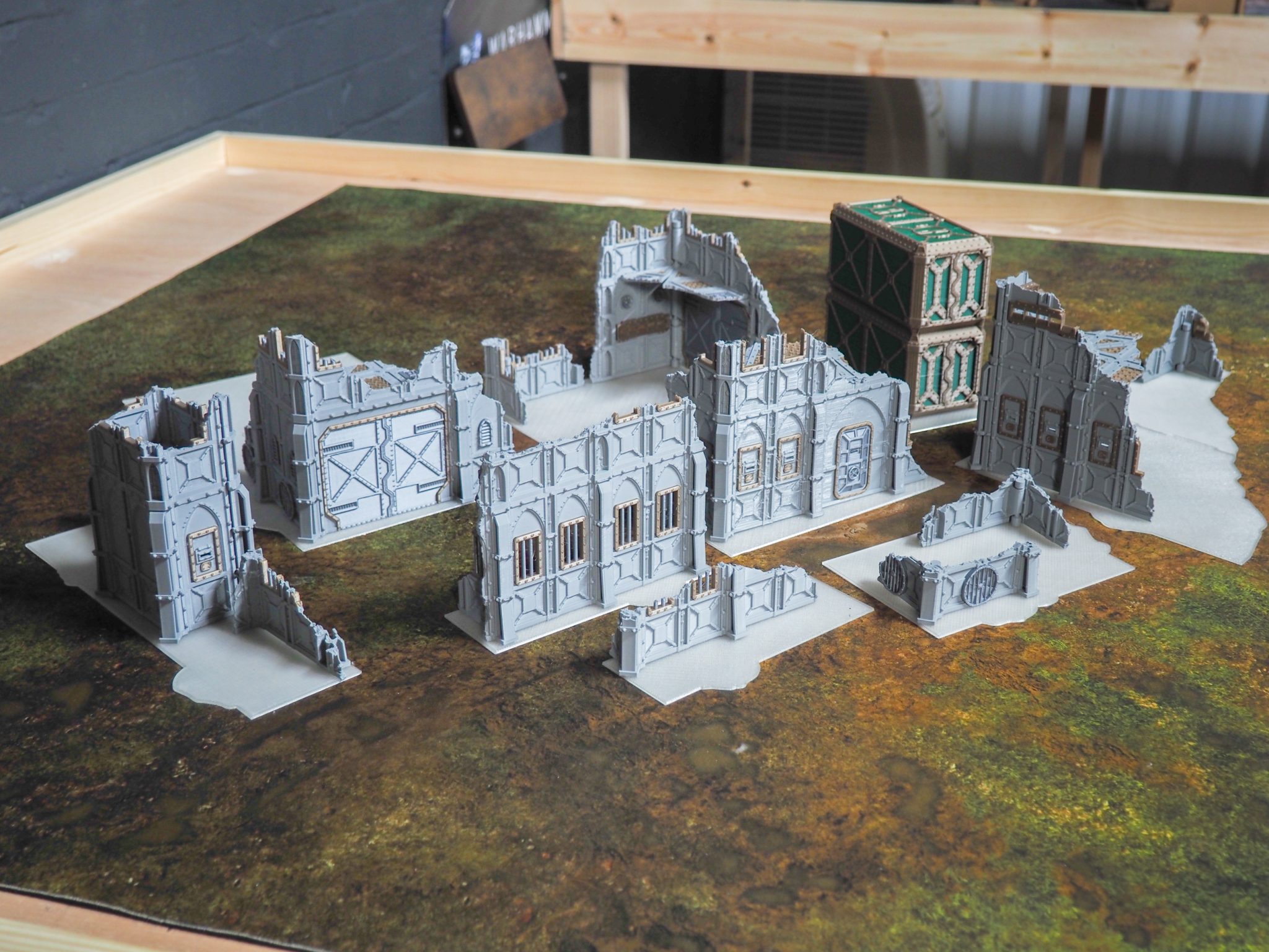 Set of 3D-printed tabletop gaming terrain featuring grey gothic ruins, barricades, and cargo containers