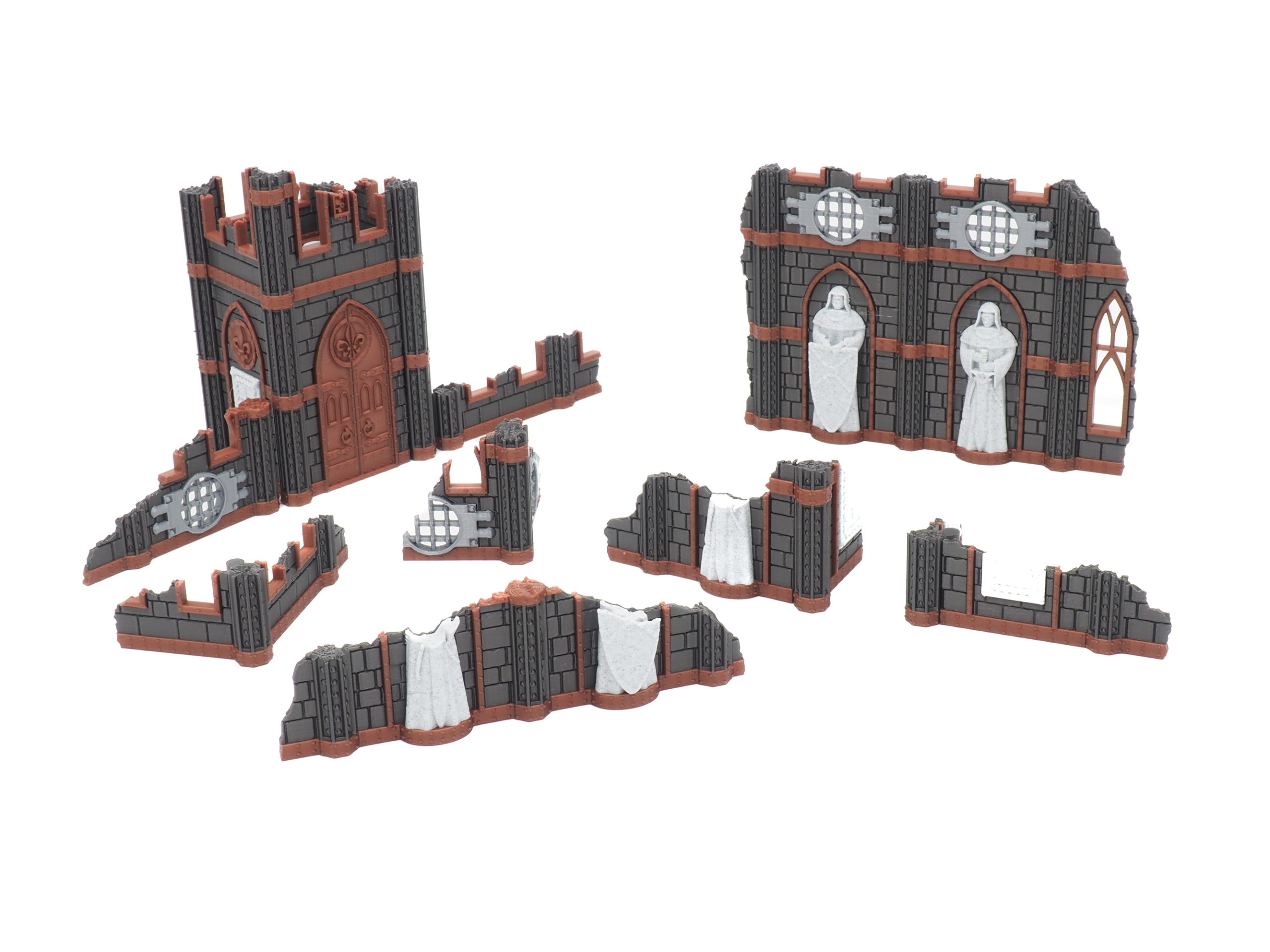 Modular 3D-printed gothic ruin terrain set with broken stone walls, a tower, and statues for tabletop gaming