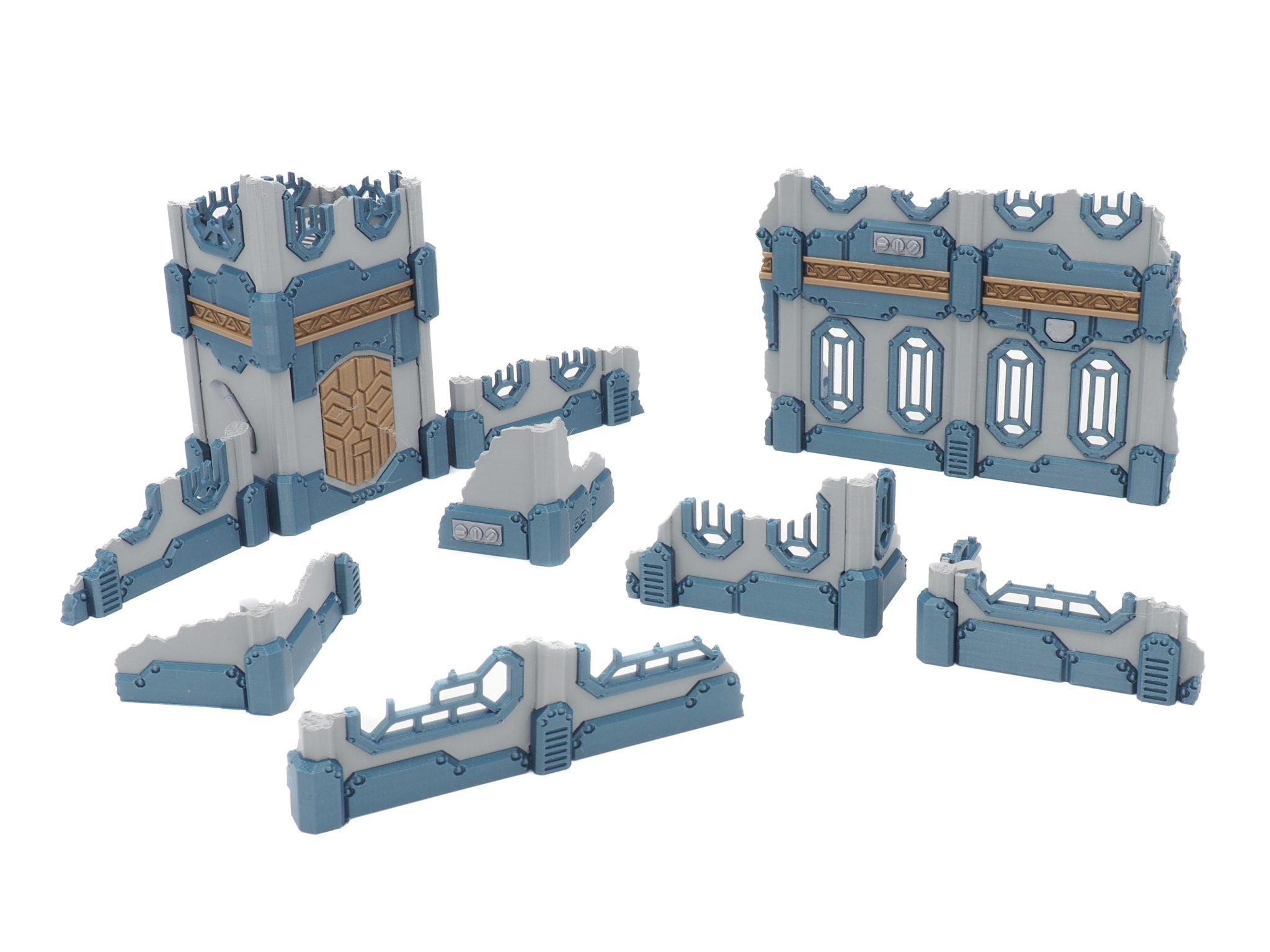 Modular 3D-printed ruined sci-fi wall and tower terrain pieces for tabletop gaming, in grey and blue with gold trim