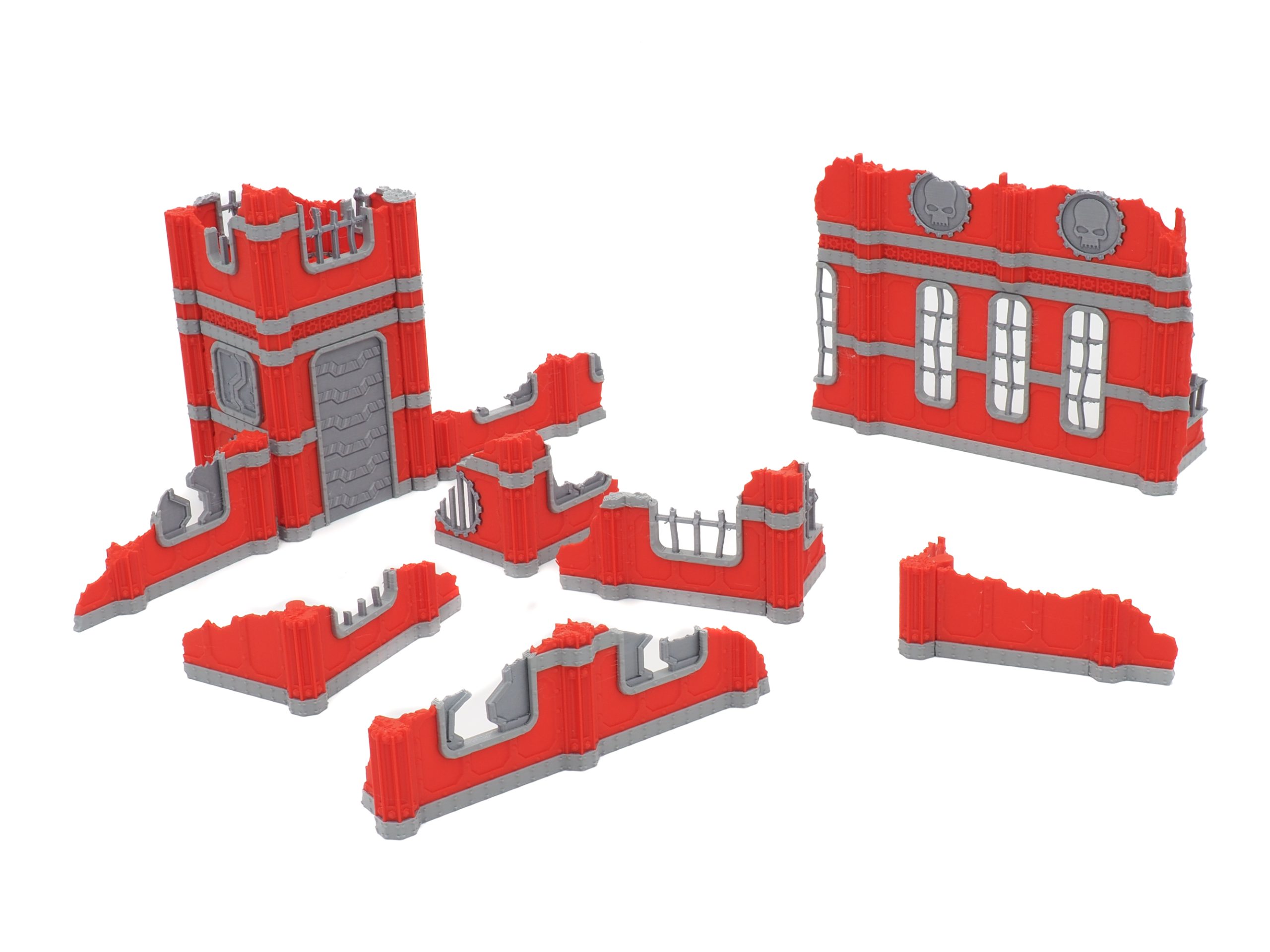 Modular red and grey 3D-printed ruined building terrain pieces for tabletop wargaming
