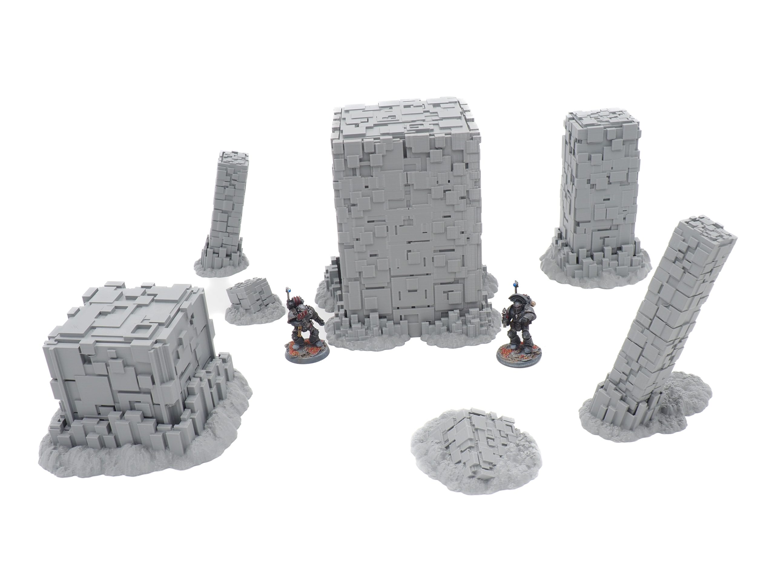 Grey 3D-printed sci-fi terrain set featuring blocky pillars and structures, shown with miniature figures for scale